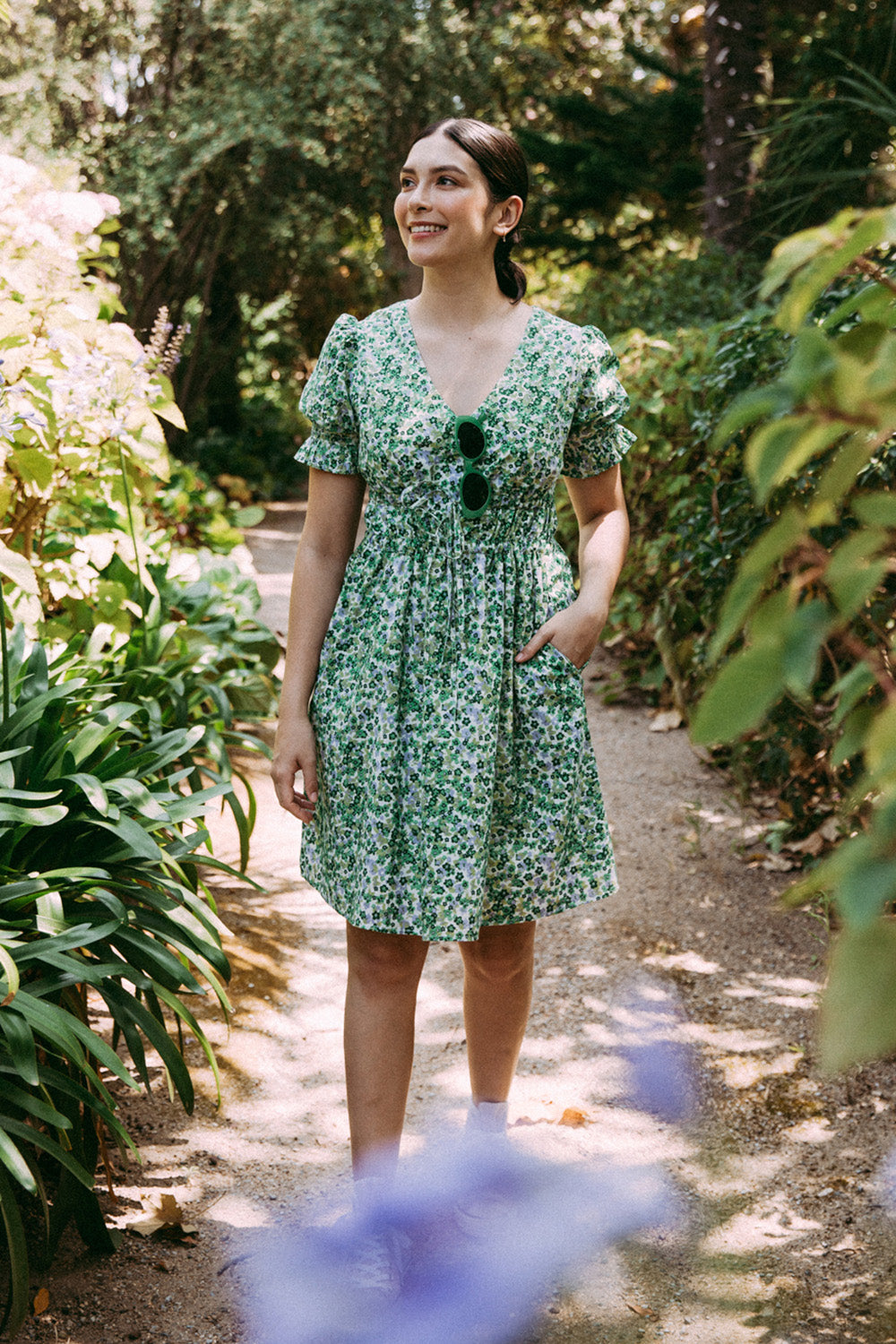 A model wearing the Prairie Floral Dress in colour Prairie (Green), from the front, showing the whole outfit