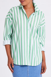 Model Olivia wearing size 10 of the Delia Shirt in colour Meadowwhit (Green), from the front, cropped image