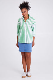 Model Olivia wearing size 10 of the Delia Shirt in colour Meadowwhit (Green), from the front, showing the whole outfit