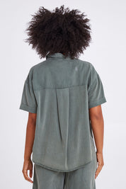 Model Olivia wearing size 10 of the Bliss Washed Shirt in colour Clover (Green), from the back