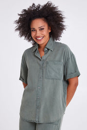 Model Olivia wearing size 10 of the Bliss Washed Shirt in colour Clover (Green), from the front, cropped image