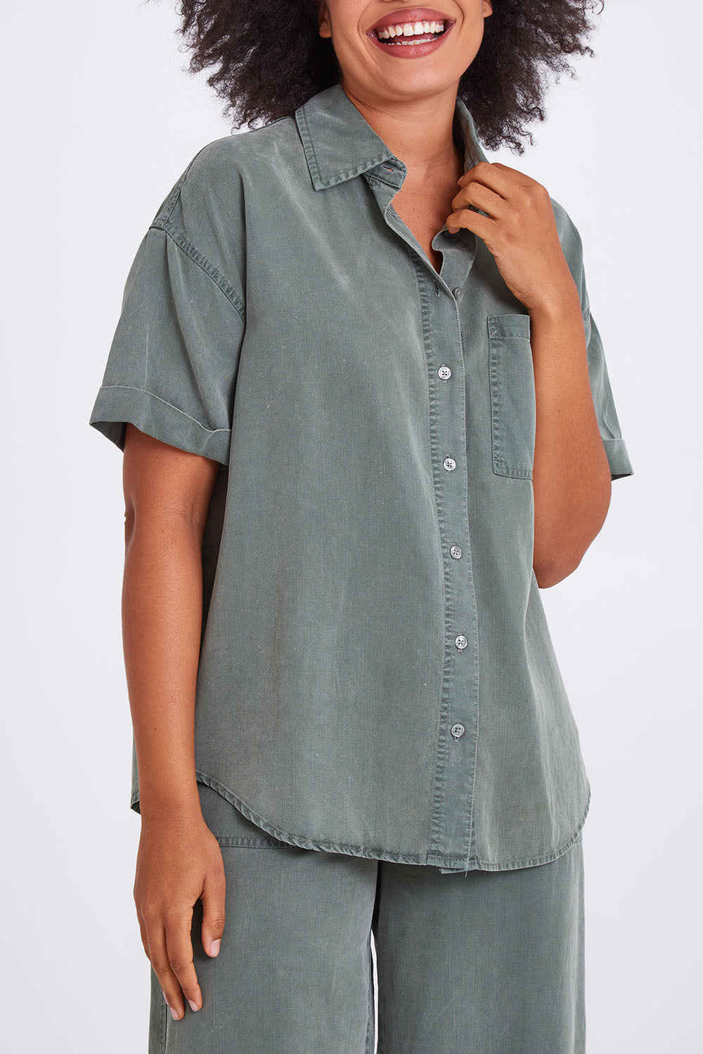 Model Olivia wearing size 10 of the Bliss Washed Shirt in colour Clover (Green), from the front, cropped image