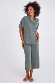 Model Olivia wearing size 10 of the Bliss Washed Shirt in colour Clover (Green), from the front, showing the whole outfit