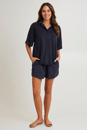 Model Madeline wearing size 10 of the Bliss Washed Short in colour Washednavy (Blue), from the front, showing the whole outfit