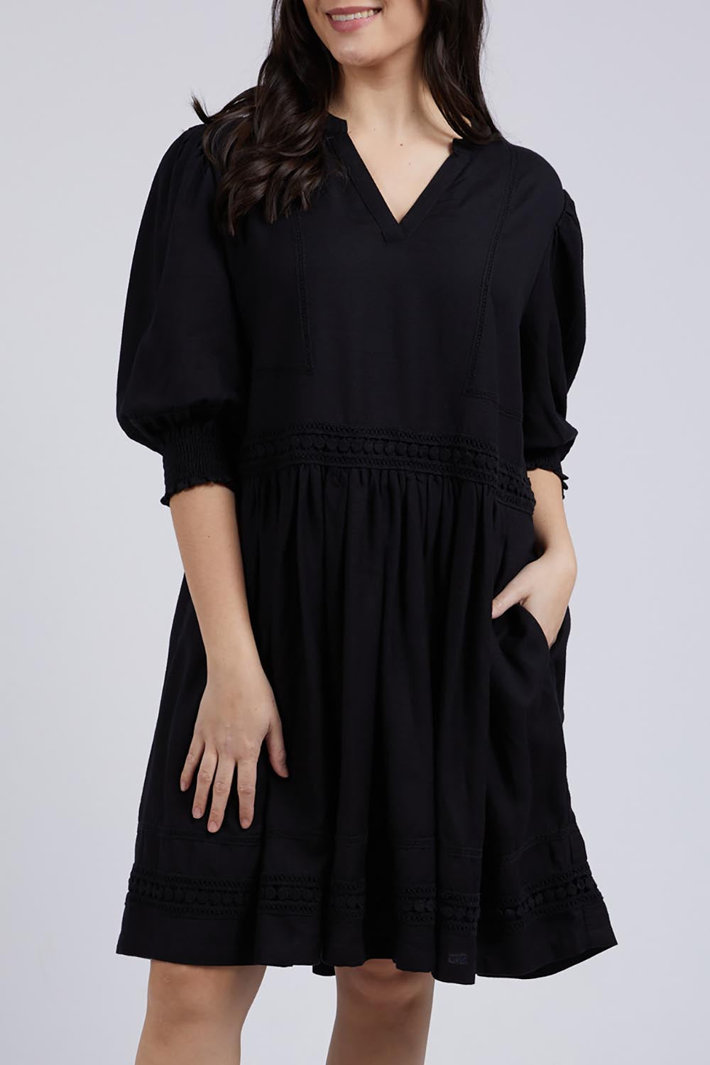 A model wearing the Market Dress in colour Black (Black), from the front, cropped image