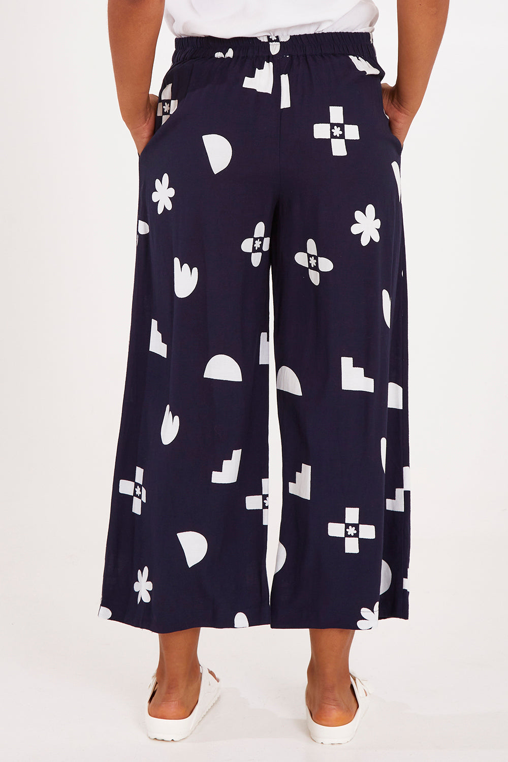 Model Olivia wearing size 10 of the Ellipse Wide Leg Pant in colour Ellipse (Blue), from the back