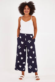Model Olivia wearing size 10 of the Ellipse Wide Leg Pant in colour Ellipse (Blue), from the front, showing the whole outfit