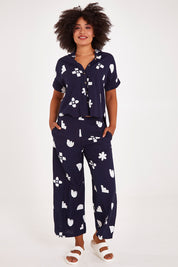 Model Olivia wearing size 10 of the Ellipse Wide Leg Pant in colour Ellipse (Blue), from the front, showing the whole outfit