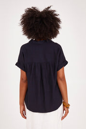 Model Olivia wearing size 10 of the Clem Shirt in colour Navy (Blue), from the back