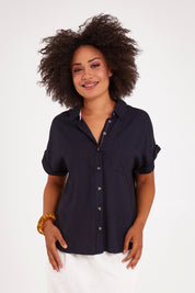 Model Olivia wearing size 10 of the Clem Shirt in colour Navy (Blue), from the front, cropped image