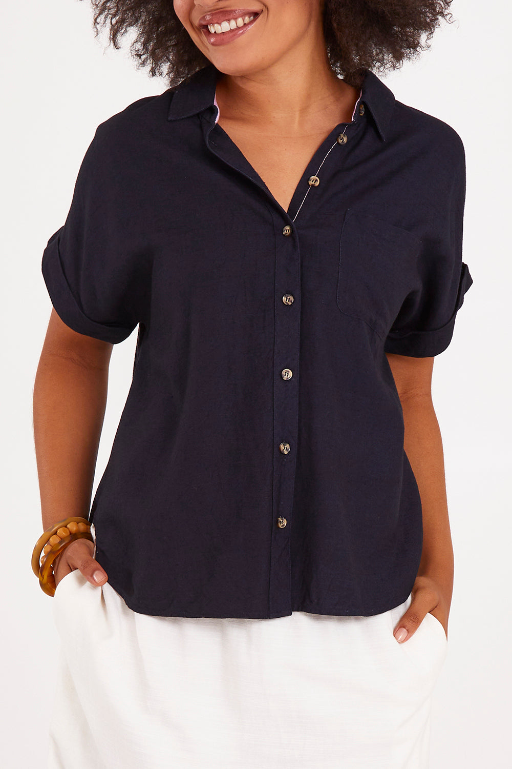 Model Olivia wearing size 10 of the Clem Shirt in colour Navy (Blue), from the front, cropped image