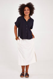 Model Olivia wearing size 10 of the Clem Shirt in colour Navy (Blue), from the front, showing the whole outfit