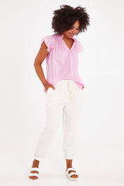 Model Olivia wearing size 10 of the Clem Relaxed Linen Blend Pant in colour Coconut (White), from the front, showing the whole outfit