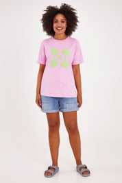 Model Olivia wearing size 10 of the Crossed Tee in colour Sweetlilac (Purple), from the front, showing the whole outfit
