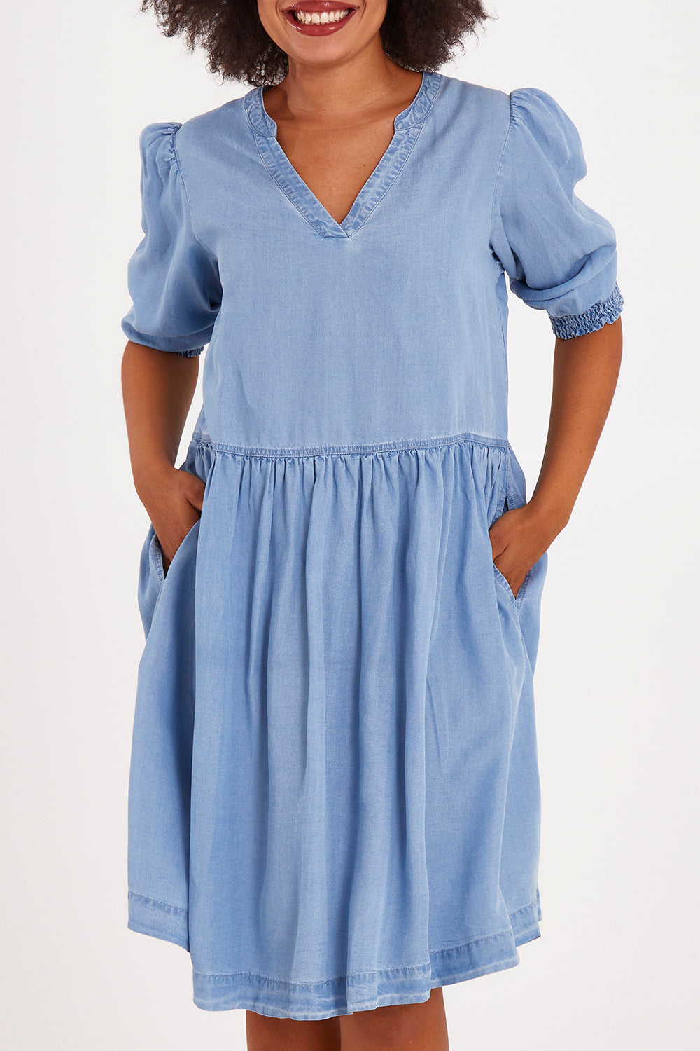Model Olivia wearing size 10 of the Shanee Chambray Dress in colour Bluewash (Blue), from the front, cropped image