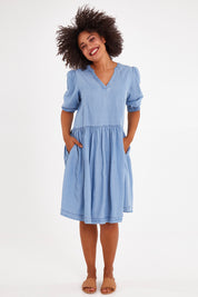 Model Olivia wearing size 10 of the Shanee Chambray Dress in colour Bluewash (Blue), from the front, showing the whole outfit
