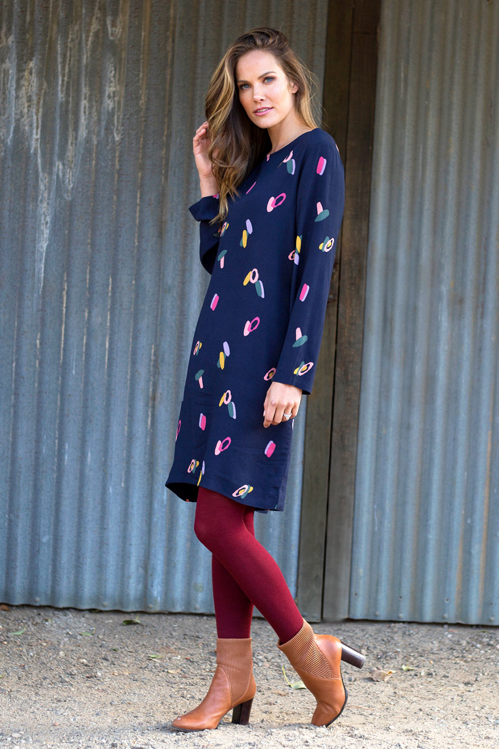 A model wearing the Falling Sherbet Dress in colour Navy (Blue), from the front, showing the whole outfit