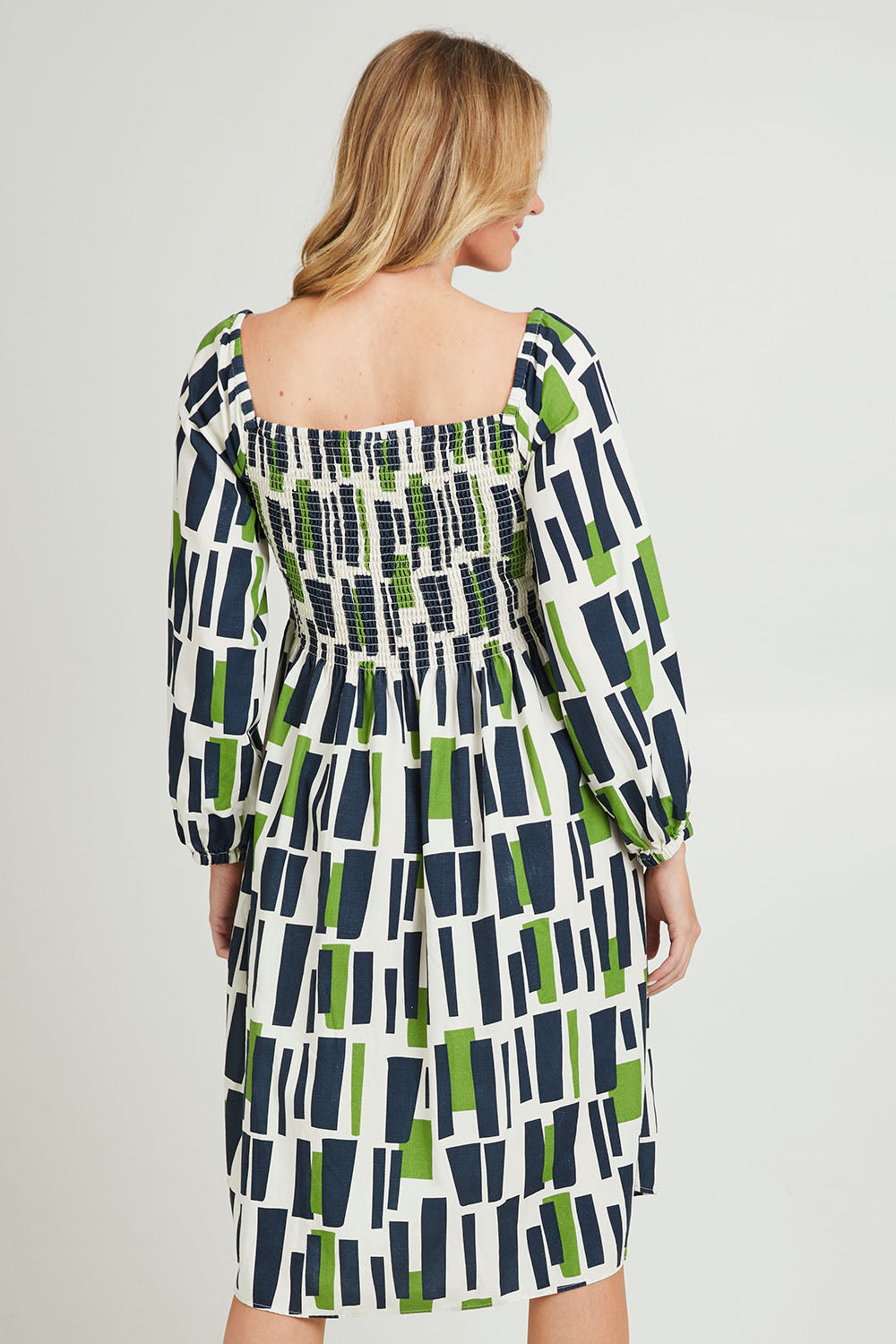 Model Grace wearing size 10 of the Valley Dress in colour Valleygeo (White), from the back