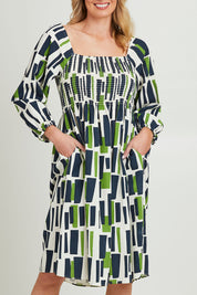 Model Grace wearing size 10 of the Valley Dress in colour Valleygeo (White), from the front, cropped image