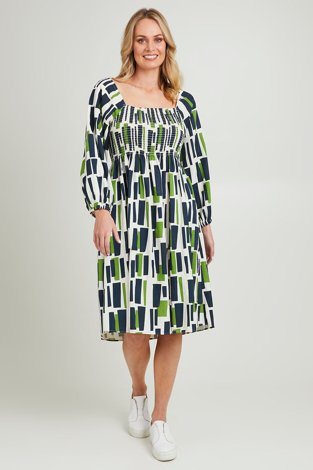 Model Grace wearing size 10 of the Valley Dress in colour Valleygeo (White), from the front, showing the whole outfit