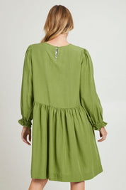 Model Grace wearing size 10 of the River Dress in colour Junglegrn (Green), from the back