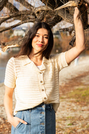 A model wearing the Bay Knit in colour Pearl, from the front, showing the whole outfit