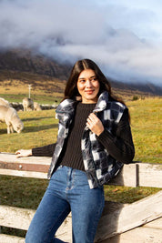 A model wearing the Cedar Check Puffer Vest in colour Navycheck (Blue), from the front, showing the whole outfit