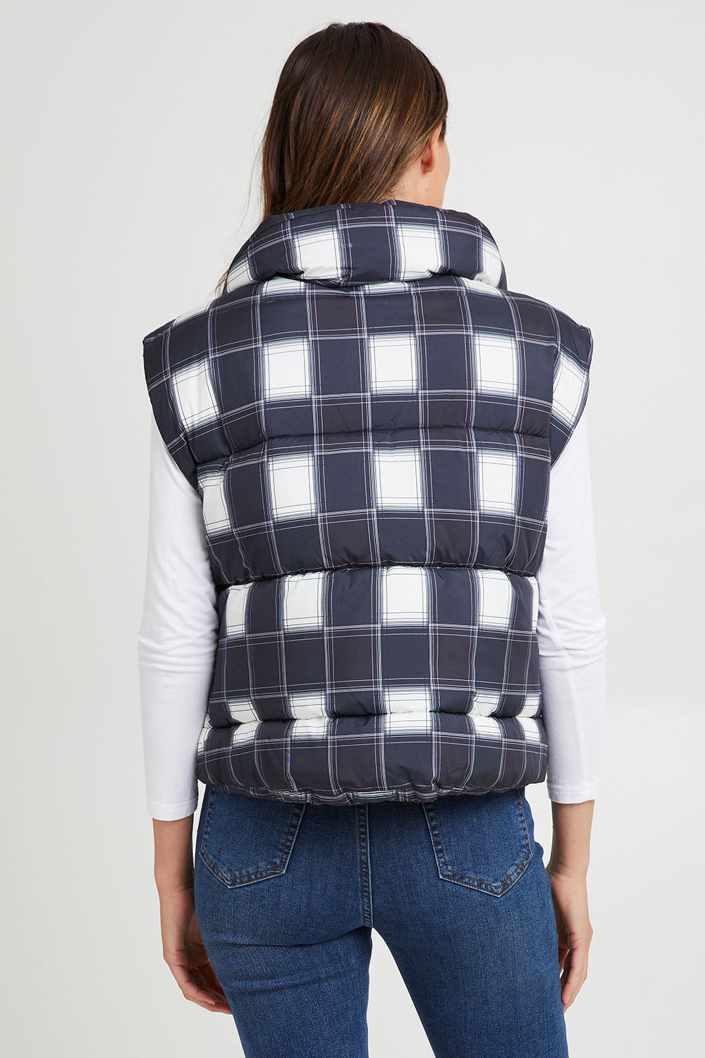 Model Madeline wearing size S of the Cedar Check Puffer Vest in colour Navycheck (Blue), from the back