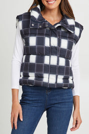 Model Madeline wearing size S of the Cedar Check Puffer Vest in colour Navycheck (Blue), from the front, cropped image