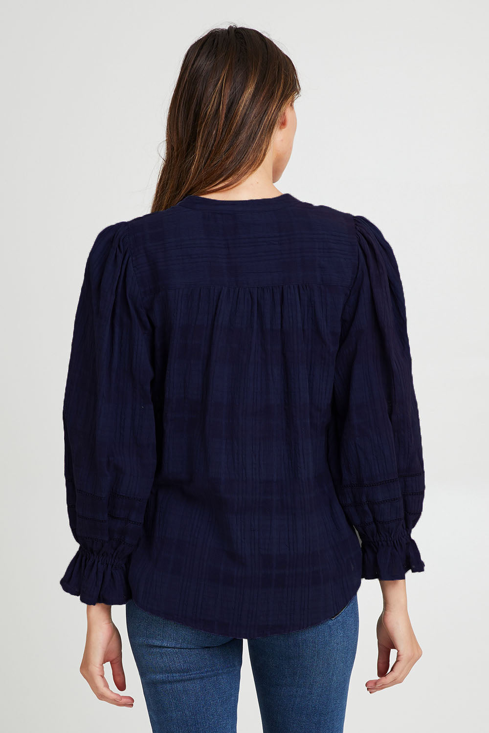 Model Madeline wearing size 10 of the Fennel Shirt in colour Navy (Blue), from the back