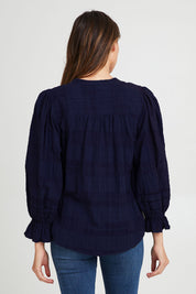 Model Madeline wearing size 10 of the Fennel Shirt in colour Navy (Blue), from the back