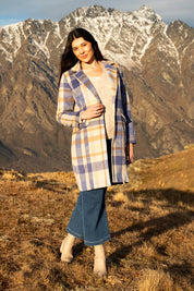 A model wearing the Cove Check Coat in colour Navyhydra (Blue), from the front, showing the whole outfit