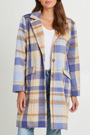 Model Madeline wearing size S of the Cove Check Coat in colour Navyhydra (Blue), from the front, cropped image