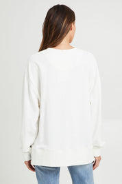 Model Madeline wearing size 10 of the Good Life Crew in colour Pearl (White), from the back
