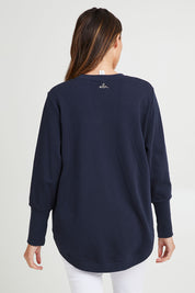 Model Madeline wearing size 10 of the Panorama Crew in colour Drksapp (Blue), from the back