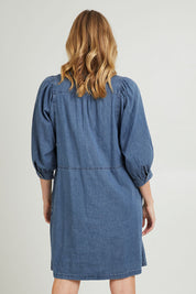 Model Grace wearing size 10 of the Filippa Dress in colour Midblue (Blue), from the back