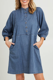 Model Grace wearing size 10 of the Filippa Dress in colour Midblue (Blue), from the front, cropped image