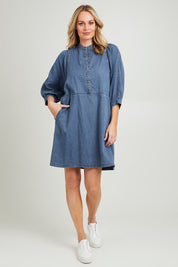 Model Grace wearing size 10 of the Filippa Dress in colour Midblue (Blue), from the front, showing the whole outfit