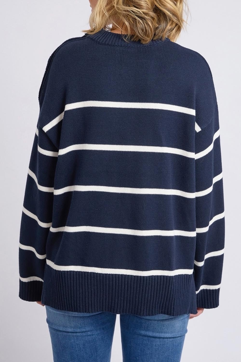 A model wearing the Iris Stripe Knit in colour Navywhite (Blue), from the back