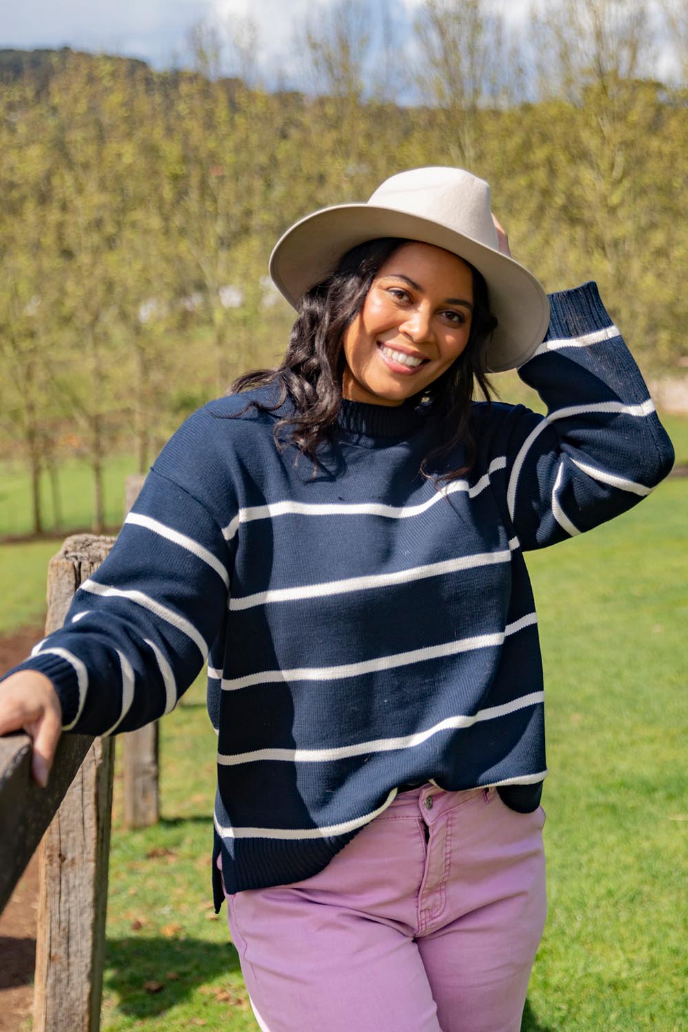 A model wearing the Iris Stripe Knit in colour Navywhite (Blue), from the front, showing the whole outfit
