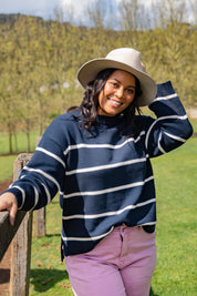 A model wearing the Iris Stripe Knit in colour Navywhite (Blue), from the front, showing the whole outfit