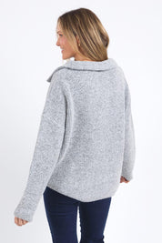 A model wearing the Bron Button Knit in colour Greymarle (Grey), from the back