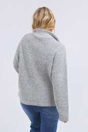 A model wearing the Bron Button Knit in colour Greymarle (Grey), from the back