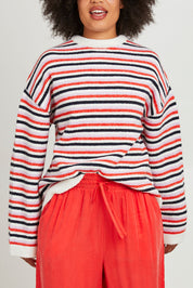 Model Olivia wearing size S of the Rye Stripe Knit in colour Peonypink (Pink), from the front, cropped image