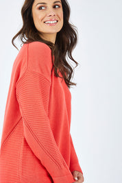 Model Shadae wearing size 10 of the Ember Knit in colour EmberGlow, from the front, cropped image