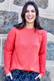 Model Shadae wearing size 10 of the Ember Knit in colour EmberGlow, from the front, showing the whole outfit