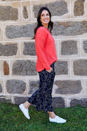Model Shadae wearing size 10 of the Ember Knit in colour EmberGlow, from the front, showing the whole outfit