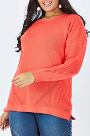 Model Shanaya wearing size 14 of the Ember Knit in colour EmberGlow, from the front, cropped image