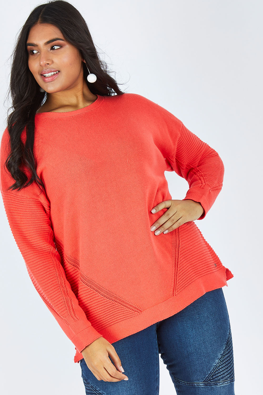 Model Shanaya wearing size 14 of the Ember Knit in colour EmberGlow, from the front, cropped image