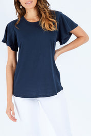 Model Madeline wearing size 10 of the Lucy Flutter Tee in colour Navy (Blue), from the front, cropped image
